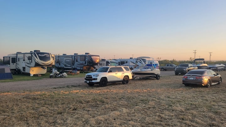 RVs, boats, and vehicles at Camp Meredithville under a Panhandle evening sky